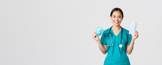 Free Photo covid coronavirus disease healthcare workers concept smiling pretty asian female nurse physician in ...