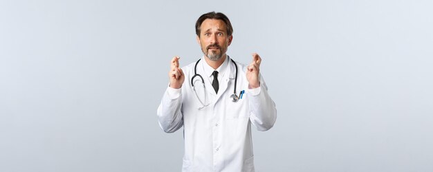 코비드 코로나바이러스 발병 의료 종사자와 전염병 개념 희망적인 불안한 남성 의사 간청