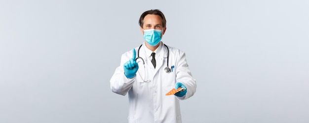 Covid preventing virus healthcare workers and vaccination concept doctor in medical mask and gloves ...