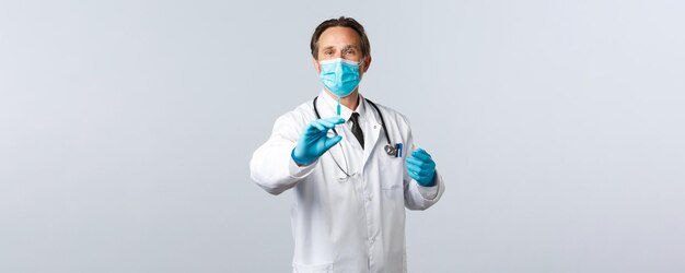 Covid予防ウイルス医療従事者と予防接種の概念中年医師の医療マスク..。