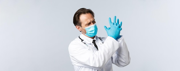 Covid preventing virus healthcare workers and vaccination concept tired doctor in medical mask and g...