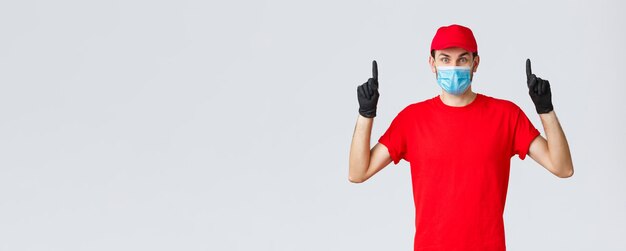 Covid selfquarantine online shopping and shipping concept surprised delivery guy in red uniform and ...