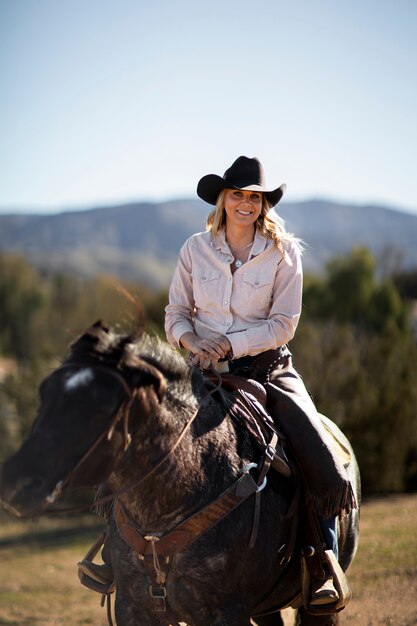 Cowboy silhouette with horse against warm light