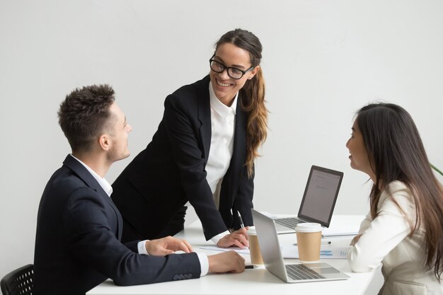 Coworkers analyzing handouts and reports during meeting