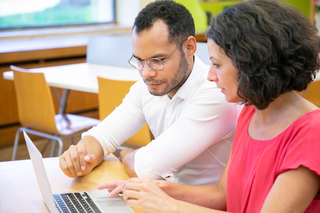 Foto gratuita collaboratori che effettuano ricerche in biblioteca