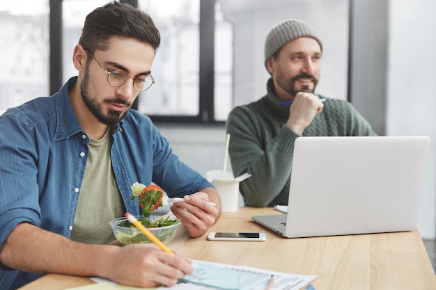 Coworkers having lunch in office