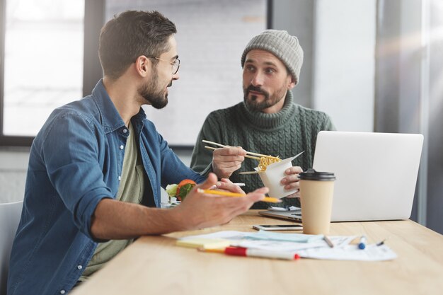 Coworkers having lunch in office