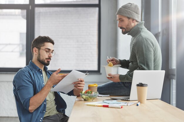 Coworkers having lunch in office