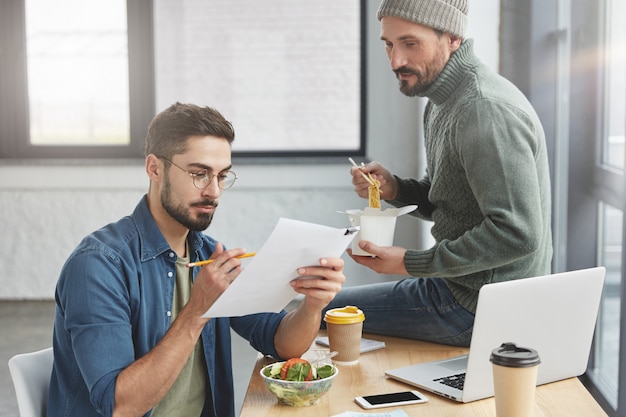 Coworkers having lunch in office