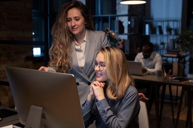 Coworkers looking the monitor