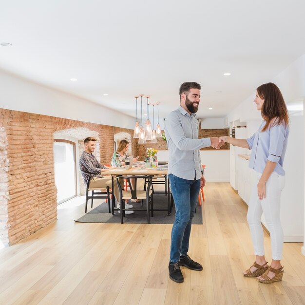 Coworkers shaking hands in office