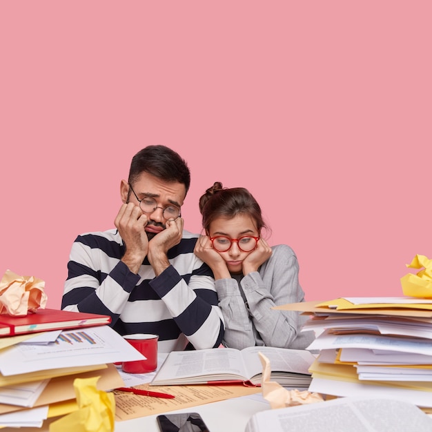 Coworkers sitting at desk with documents