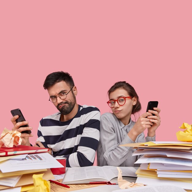 Coworkers sitting at desk with documents