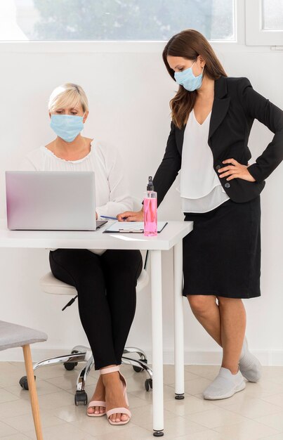 Coworkers wearing protection mask and working