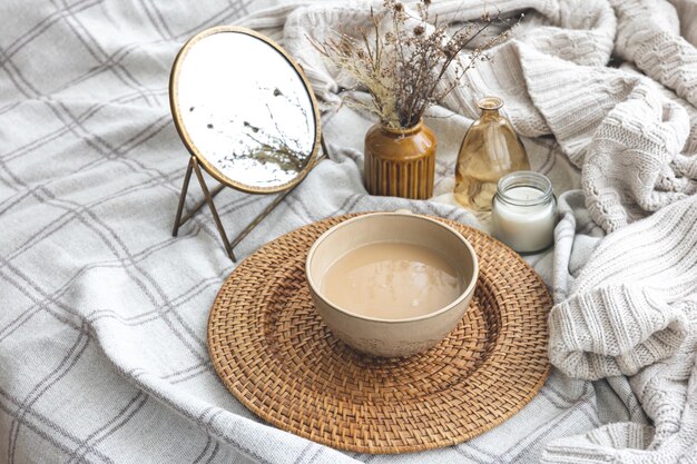 Cozy autumn composition with a cup of coffee and candles in bed