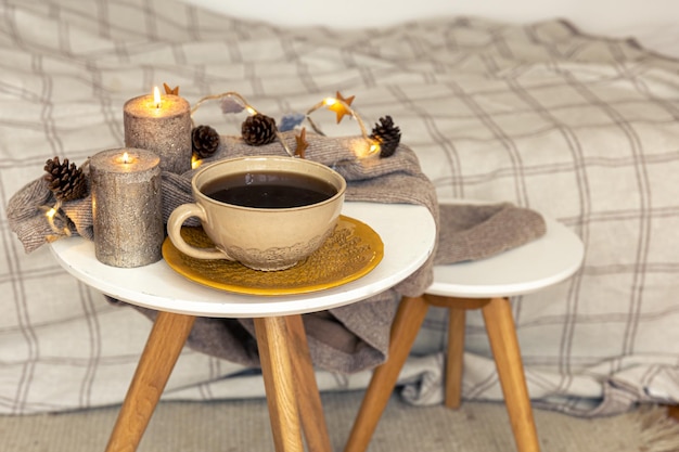 Cozy autumn composition with a cup of tea and decorative details