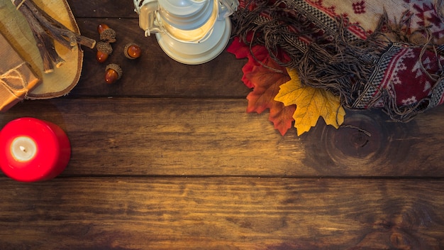 Free photo cozy autumn composition with lantern and leaves