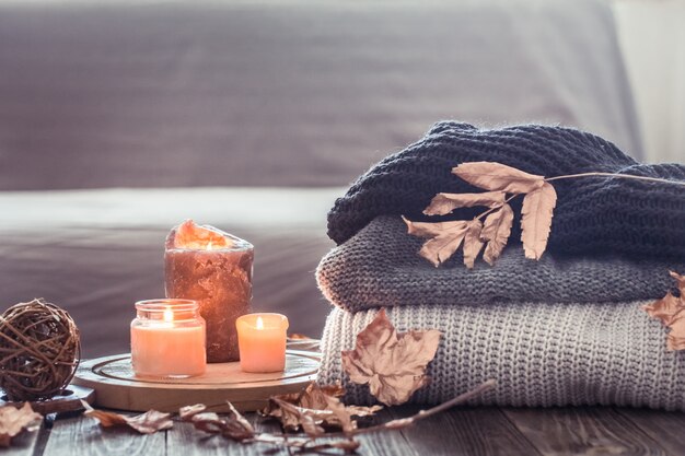 Cozy autumn still life with candles and a sweater