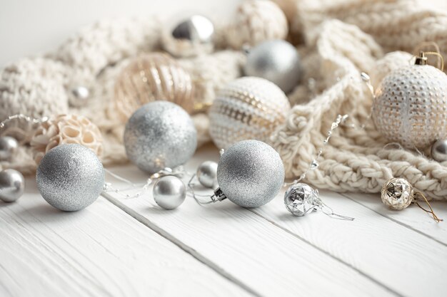 Cozy Christmas festive background with Christmas balls and knitted element.