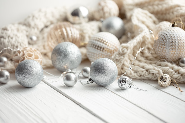 Cozy Christmas festive background with Christmas balls and knitted element.
