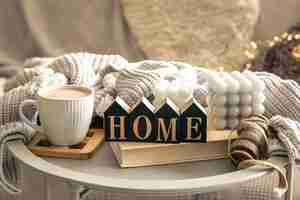 Free photo cozy composition with candles coffee and decorative word home