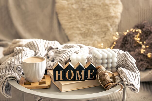 Cozy composition with candles coffee and decorative word home