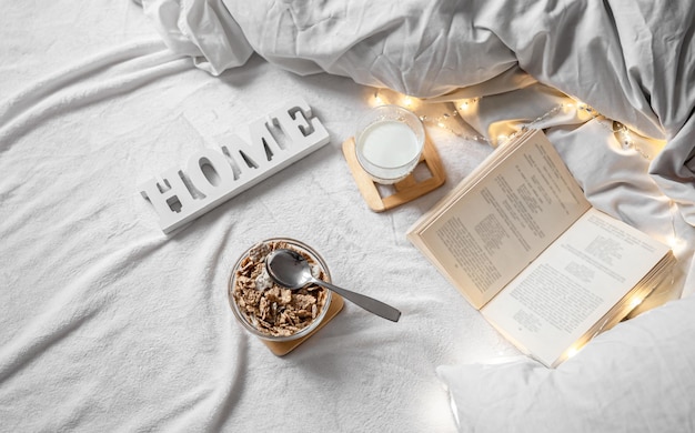 Cozy composition with cereal and milk in bed