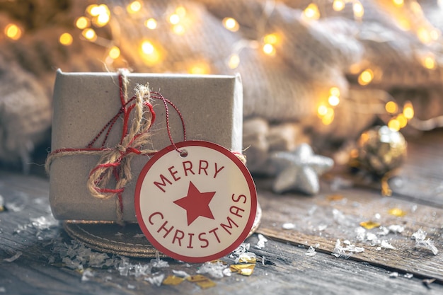 Free photo cozy composition with a christmas gift box on a blurred background