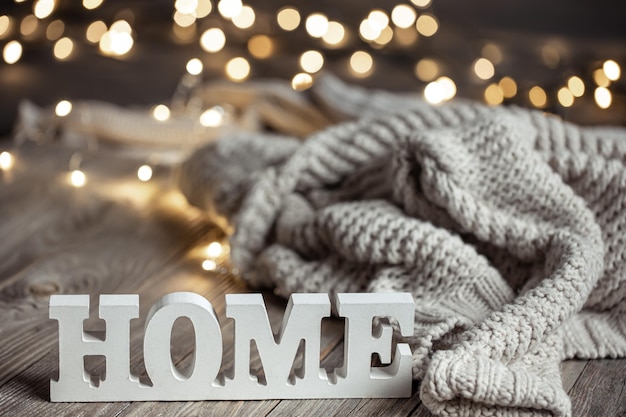 Free photo cozy composition with a decorative word home and knitted element