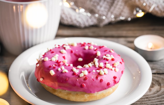 Free photo cozy composition with donut and cup of tea