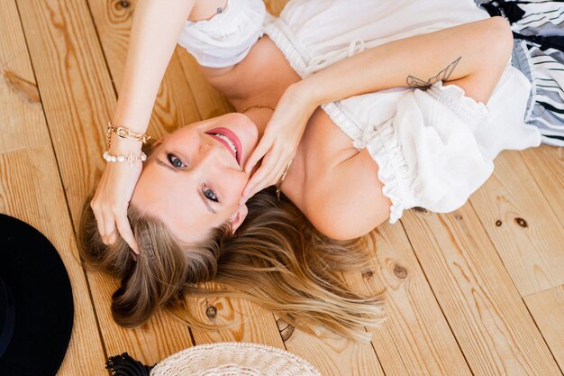 Cozy home atmosphere. Stylish blond  woman in  linen wear  posing in light modern interior studio.