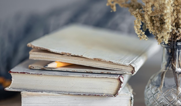 Cozy home composition with books on the table closeup