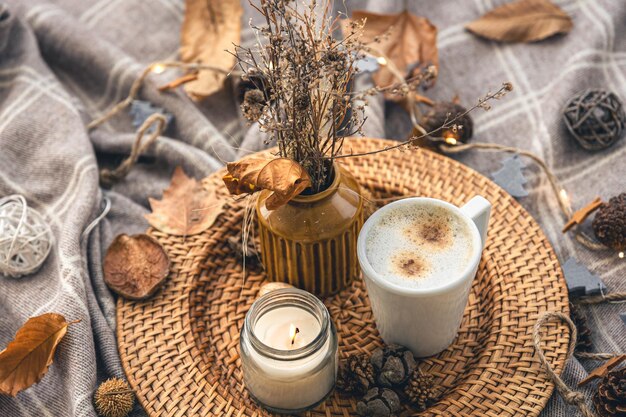 Cozy home composition with a cup of coffee a candle and decorative details