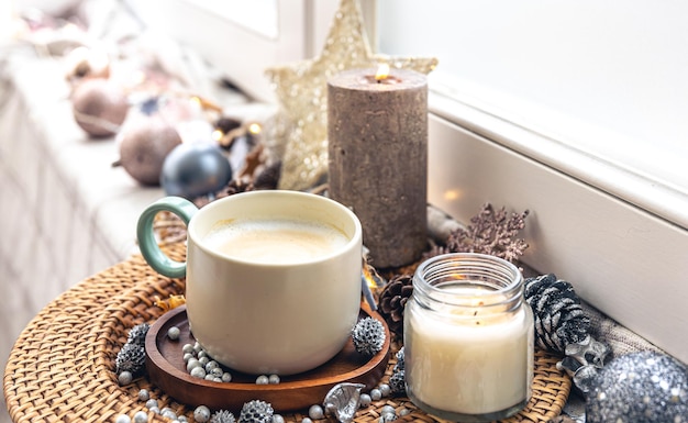 Cozy home composition with a cup of coffee and decor closeup