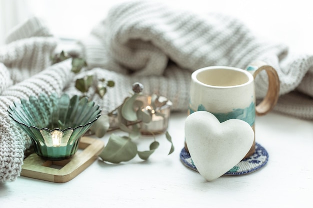 Cozy home composition with cup and decorative heart