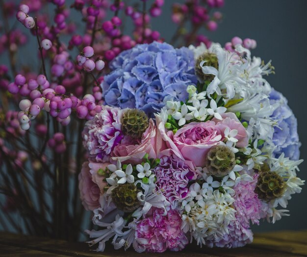 A cozy, pretty bouquet of blue and purple combination of flowers.