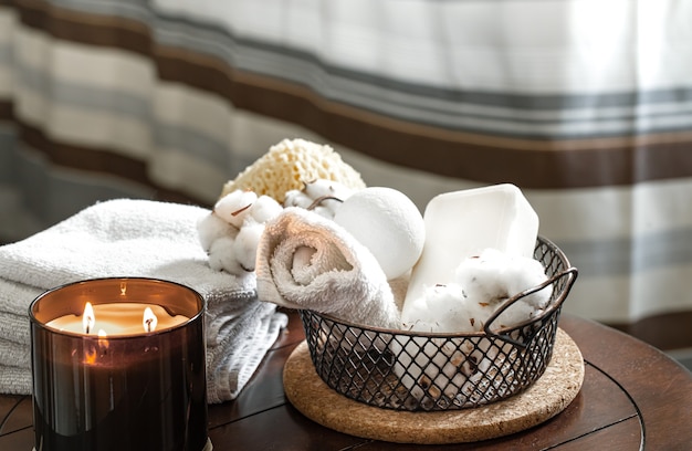 Cozy spa composition of aroma of candles and bath towels, soap. Body care and hygiene concept.
