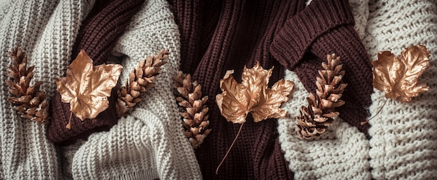 Cozy sweaters and gold leaves .