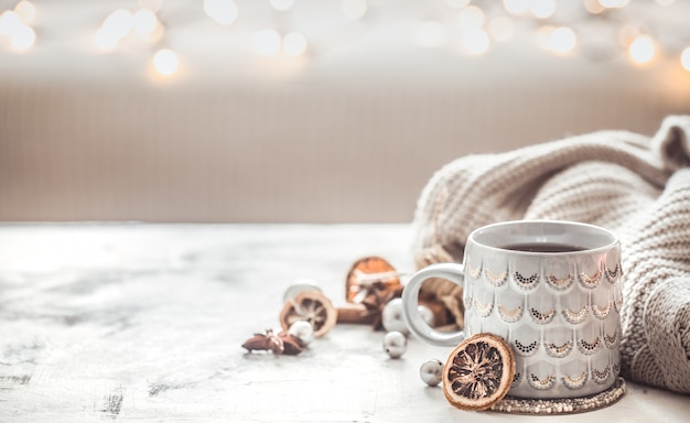 Cozy winter composition with a cup and sweater