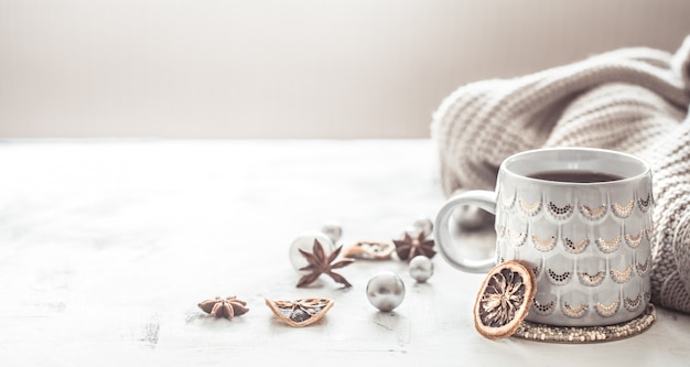 cozy winter composition with a cup and sweater