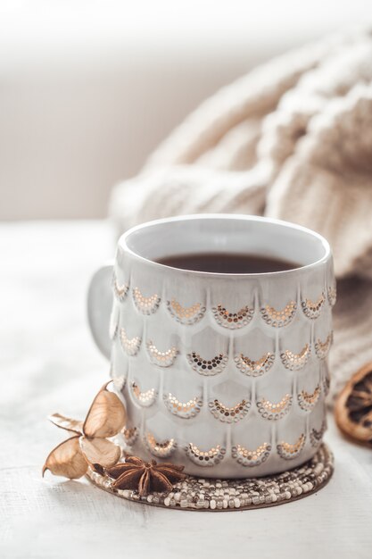 cozy winter composition with a cup and sweater