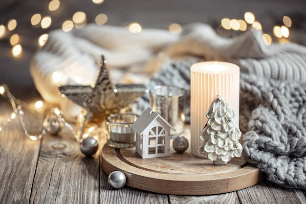 Cozy winter composition with decor details on blurred background with bokeh