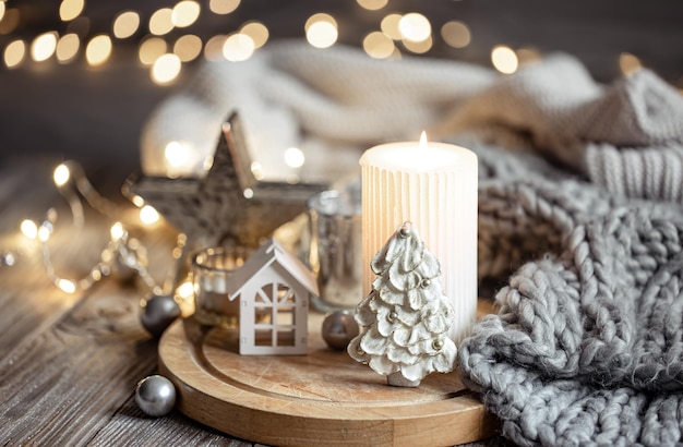 Cozy winter composition with decor details on blurred background with bokeh