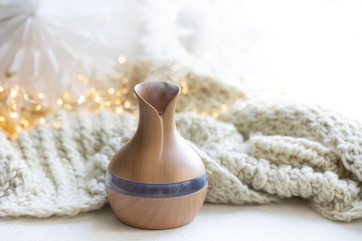 Free Photo cozy winter composition with essential oil aroma diffuser