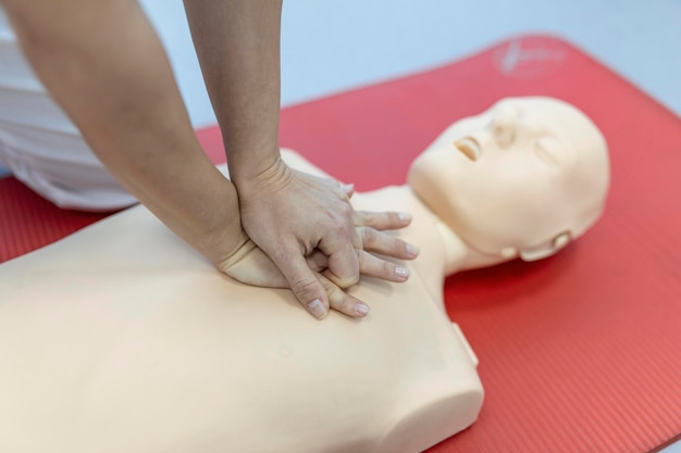 강사가 응급 처치 압박 및 소생 절차를 설명하고 시연하는 CPR 수업 Cpr 더미