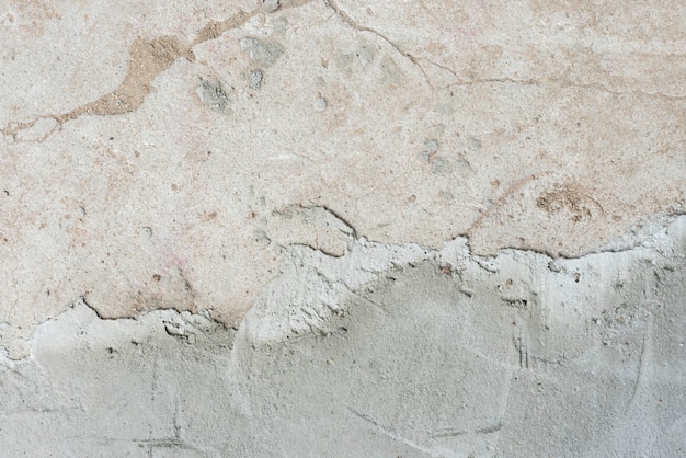 Трещины бетонной стены текстуры фона