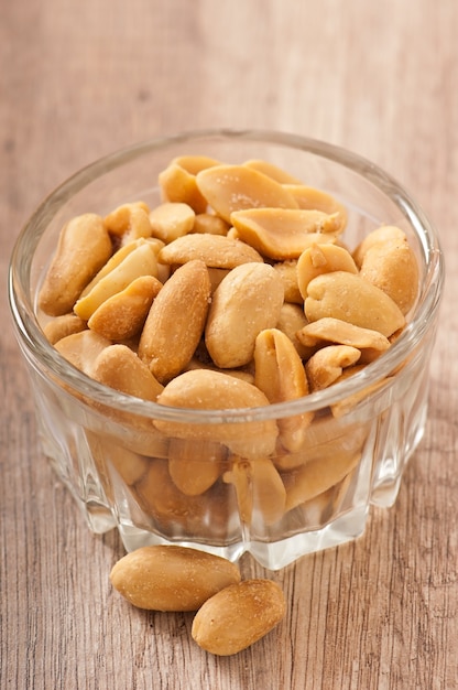 Cracked and dried peanuts in a glass