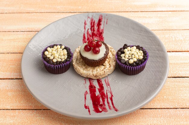 cracker and cake with cranberries on top inside purple plate with brownies