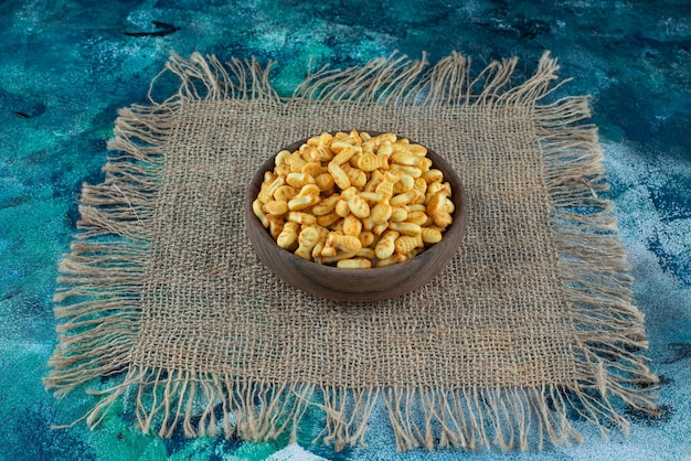 Cracker fish in bowl on a texture on the marble surface