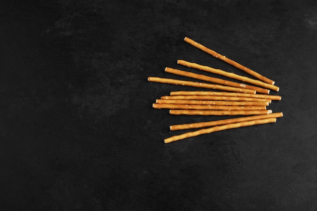 Cracker sticks on a black background.